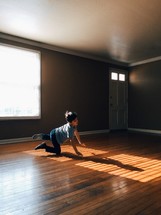 a child crawling on the floor in sunlight 