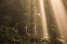 rays of sunlight shining down on hikers 