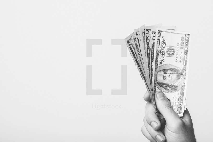 hand holding up money