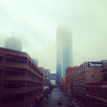 skyscraper in a foggy city