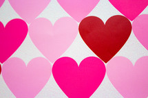 Rows of hearts in shades of pink and red.