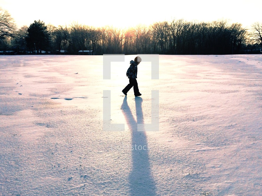 boy child walking in snow 