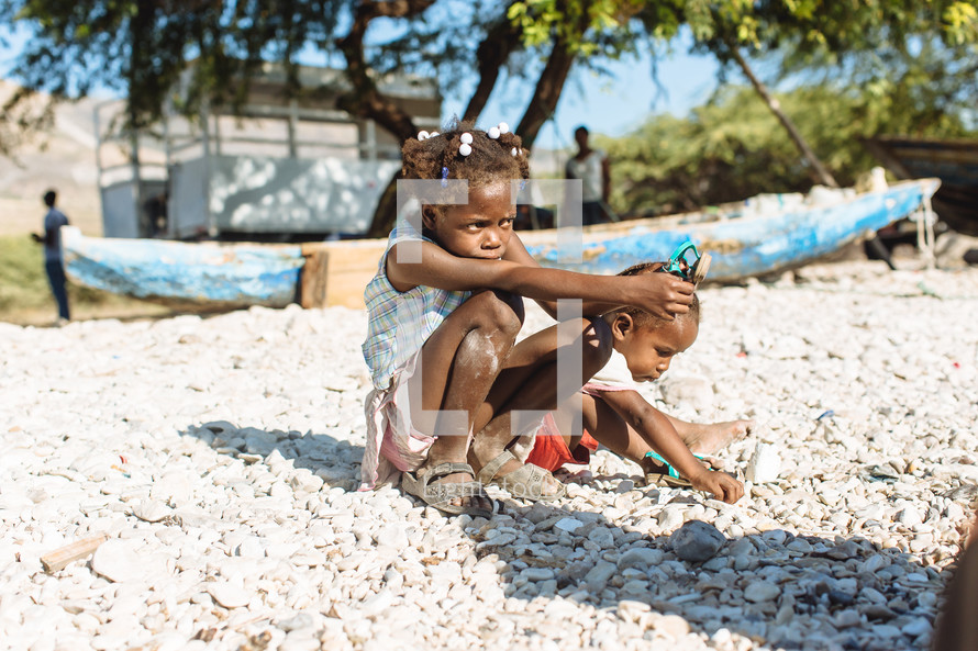children sitting on a beach in Haiti