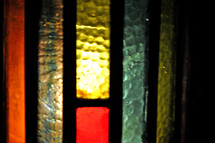 Stained glass candle shield.