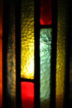Stained glass candle shield.