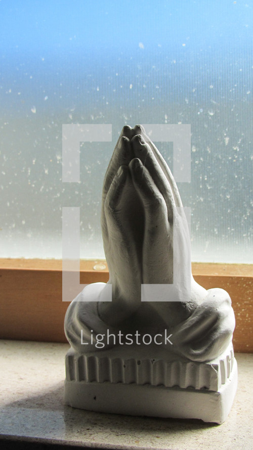figurine of praying hands 