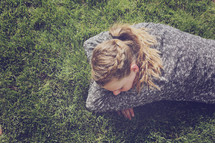 girl lying on grass