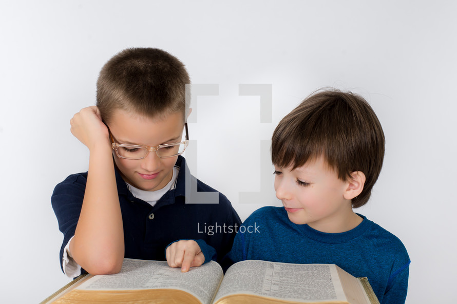 Boys reading the Bible.