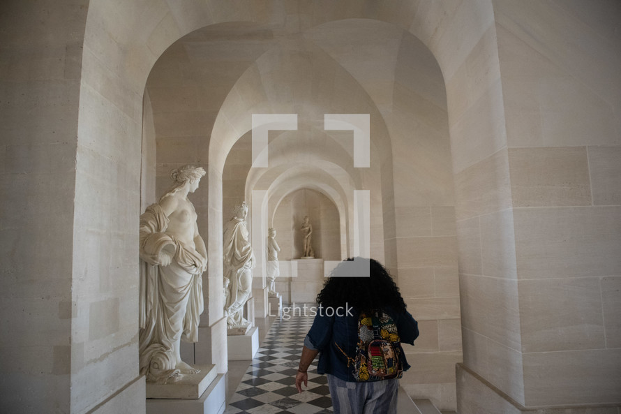 a woman walking the halls of the Vatican 