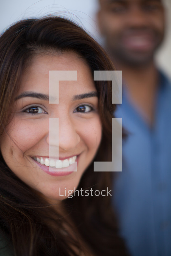 head shots of a man and woman smiling