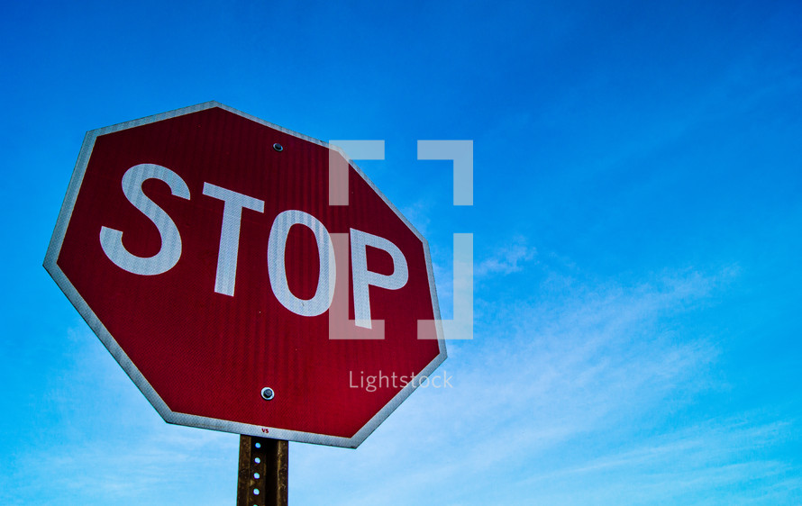 stop sign against a blue sky