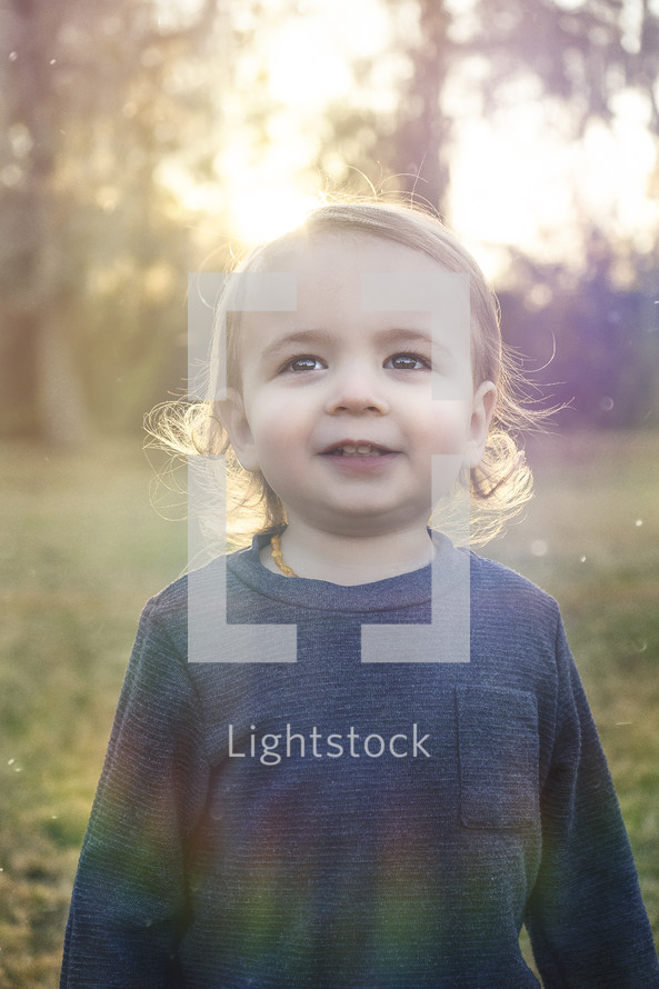 sunlight on the face of a toddler boy 