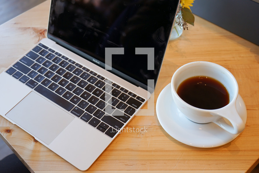 laptop computer and coffee cup