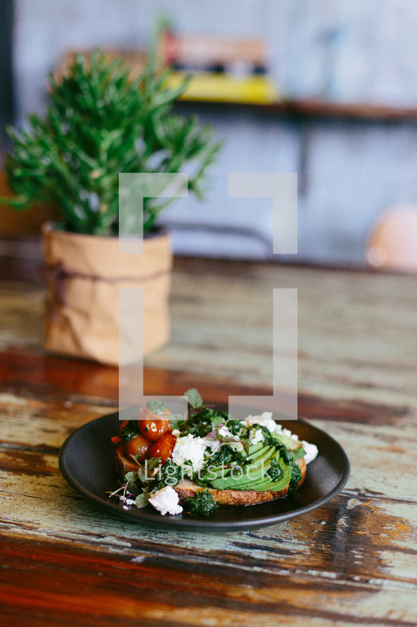 food on a plate and house plant on a table 