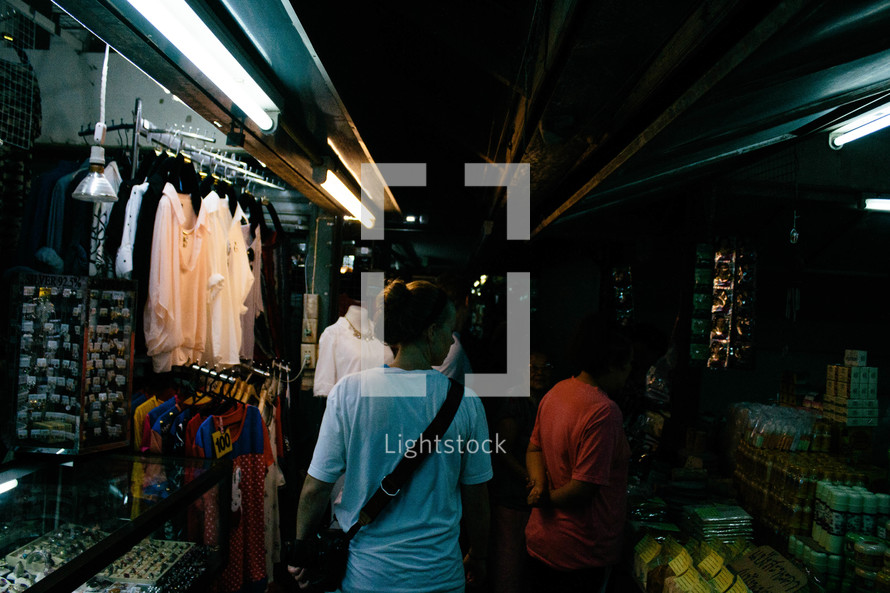 people shopping in a dark market 