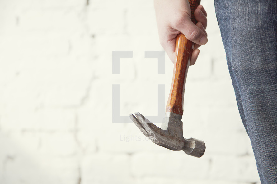 Holding a hammer.