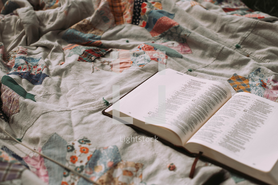 opened Bible on a bed 