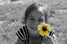 girl child with a yellow flower 