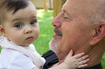 grandfather holding his infant granddaughter 