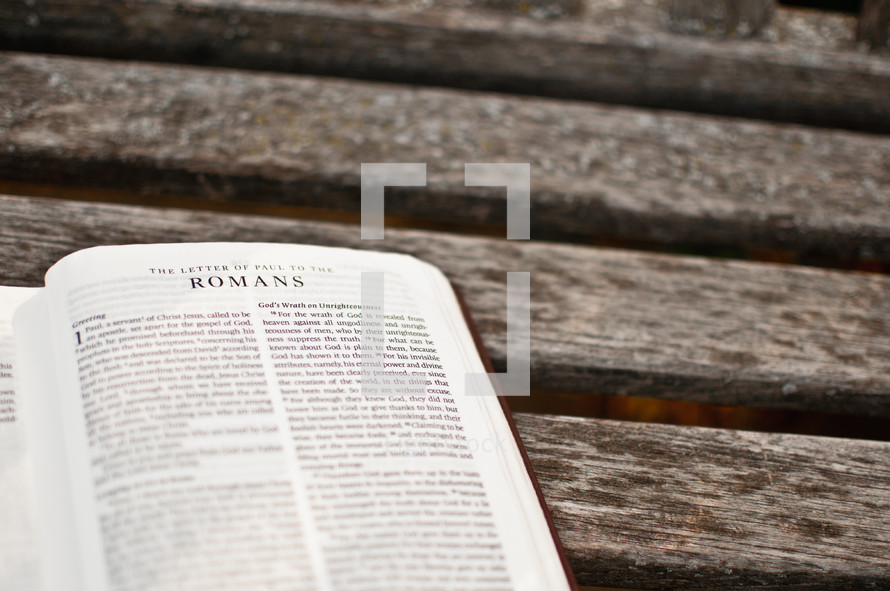 a Bible open to Romans 