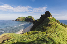 A hilly coastline covered in green grass.
