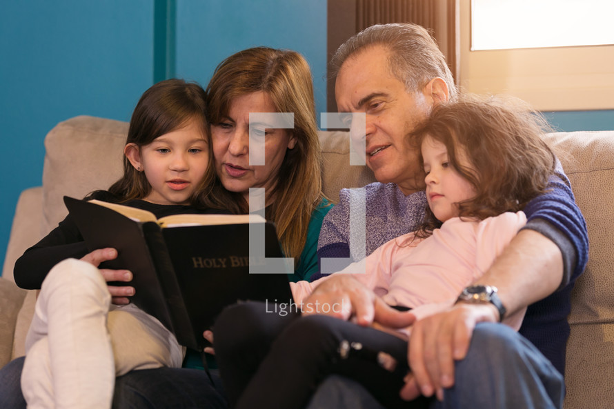 family reading a Bible together 