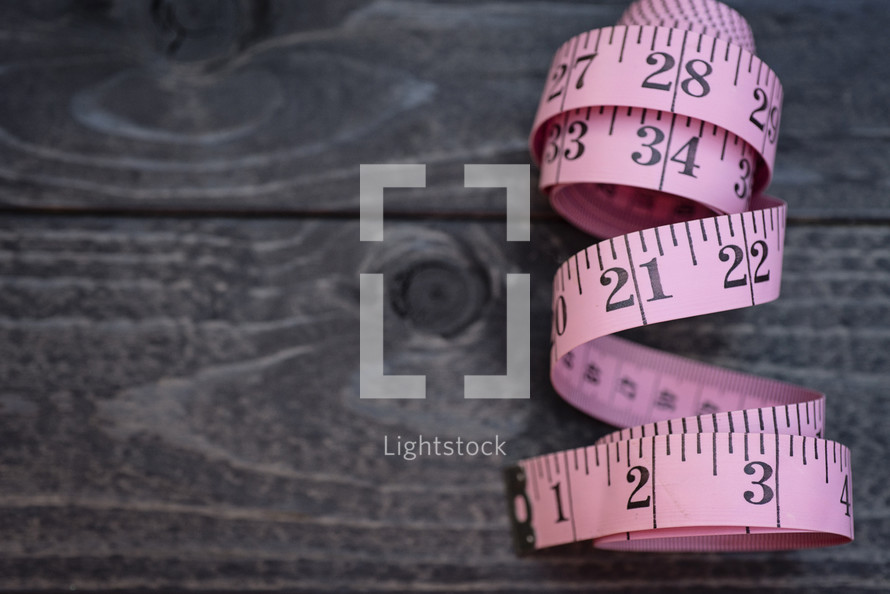 measuring tape on wood background 