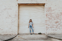 woman standing in front of a garage door 