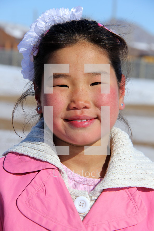 Smiling face of a Mongolian girl child 