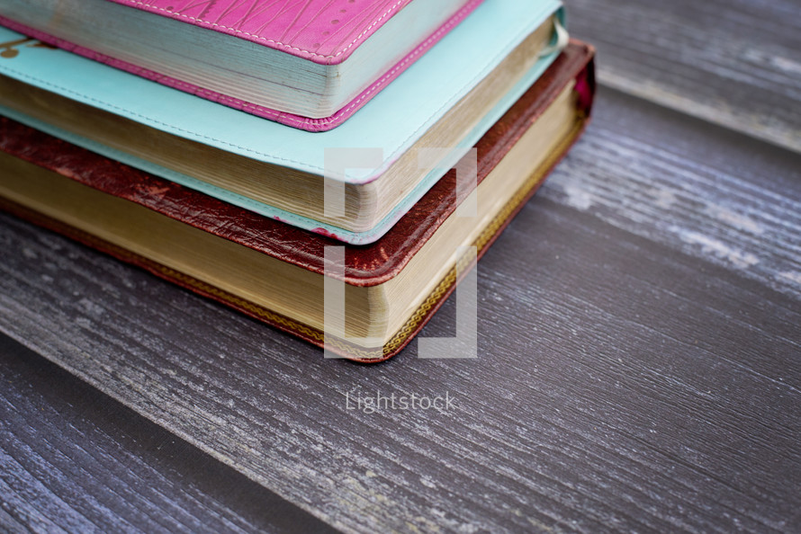 stacked Bibles on wood 