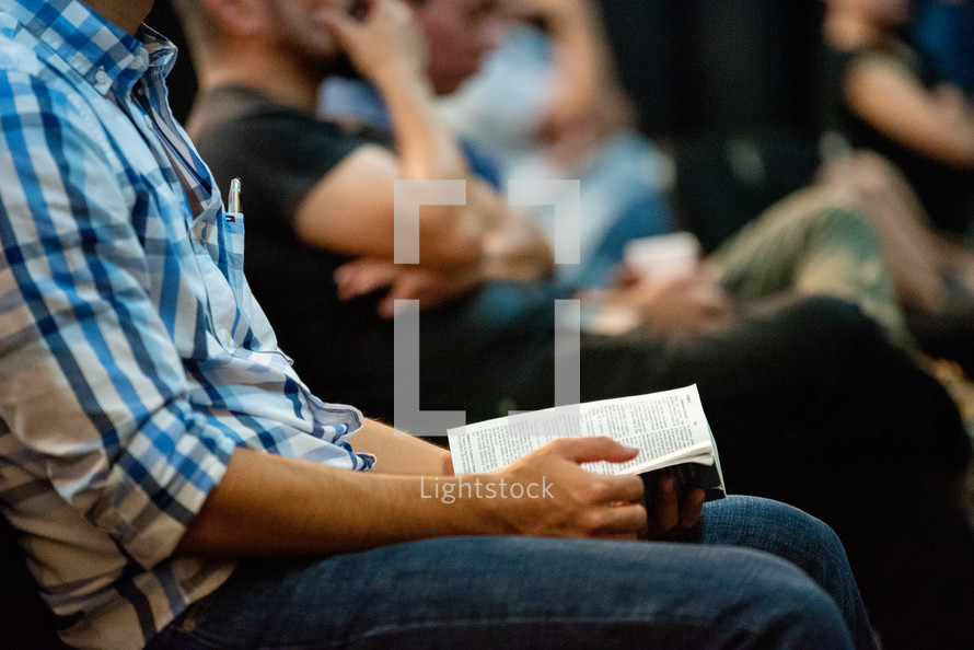men sitting with Bibles in their lap 
