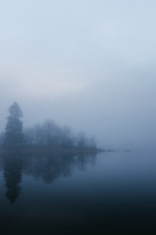 a lake in morning fog 