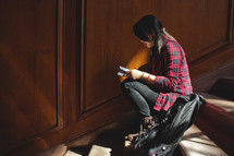 a young woman sitting in a stair well studying 