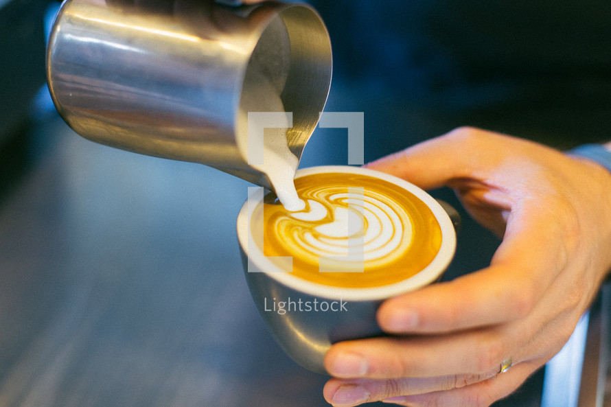 man pouring cream in coffee 