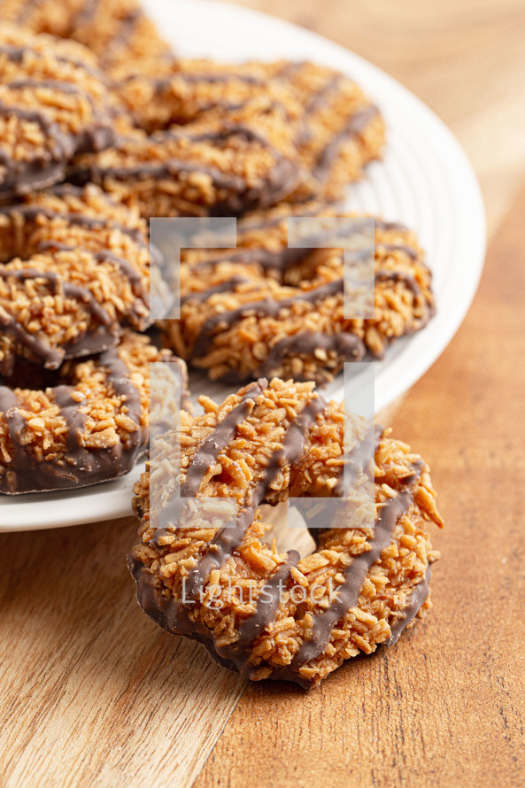 Coconut Caramel Fudge Striped Cookies on a Wood Kitchen Table