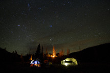 tents under a night sky full of stars 