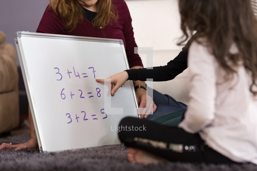 a mother teaching her children math 