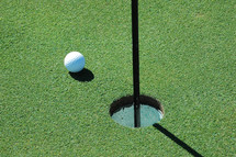 golf ball by the hole 