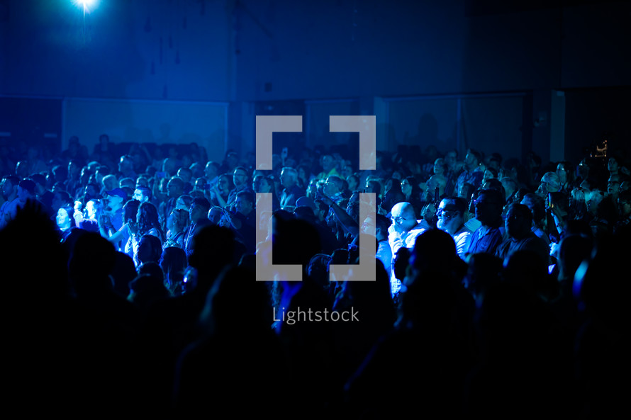audience under blue light 