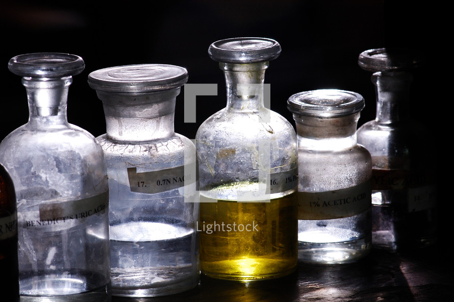glass jars full of liquid chemicals 