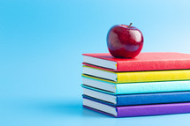 apple on a stack of school books 