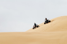 riding ATV's on sand dunes 