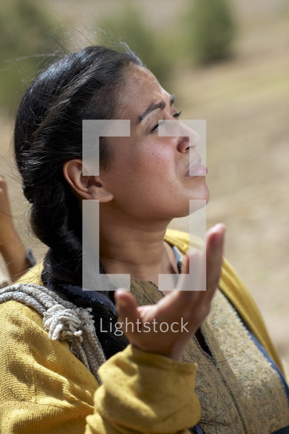 woman of the Bible with face turned to God in prayer 