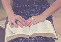 woman reading a Bible on her lap 