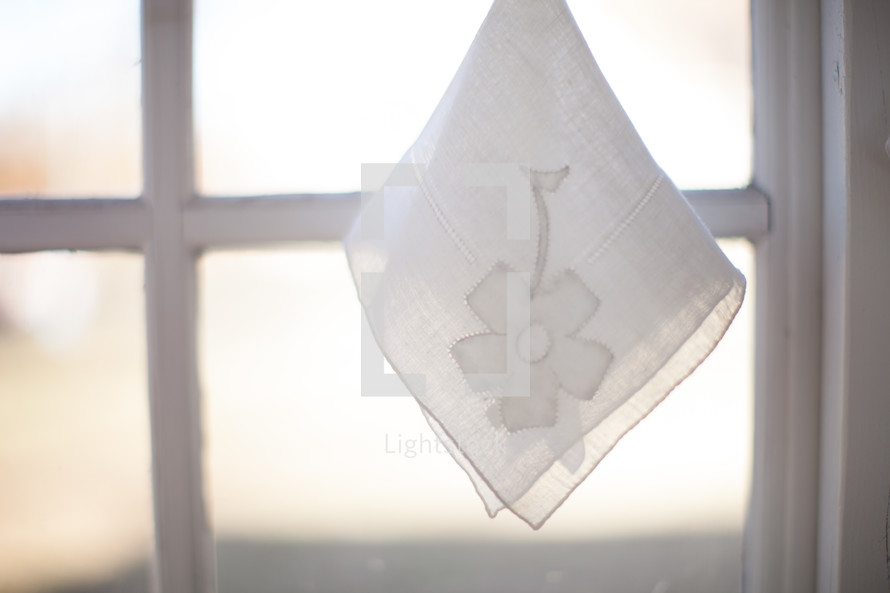 Handkerchief hanging in the window.