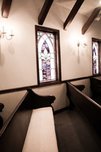 stained glass windows and church pews