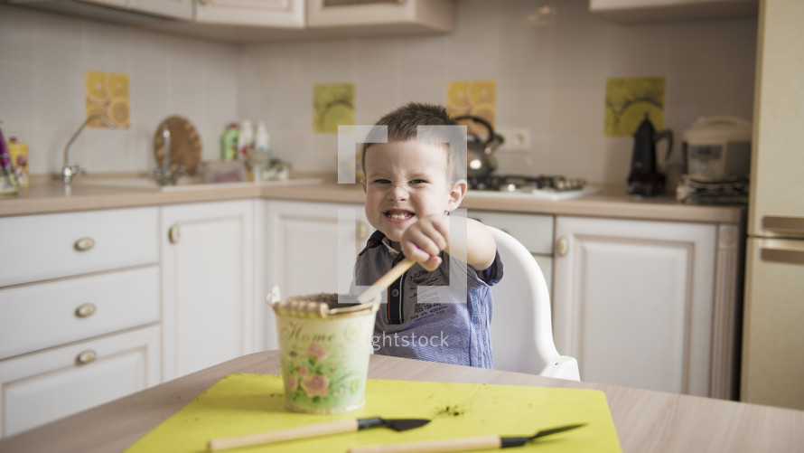 boy planting seeds in a kitchen 