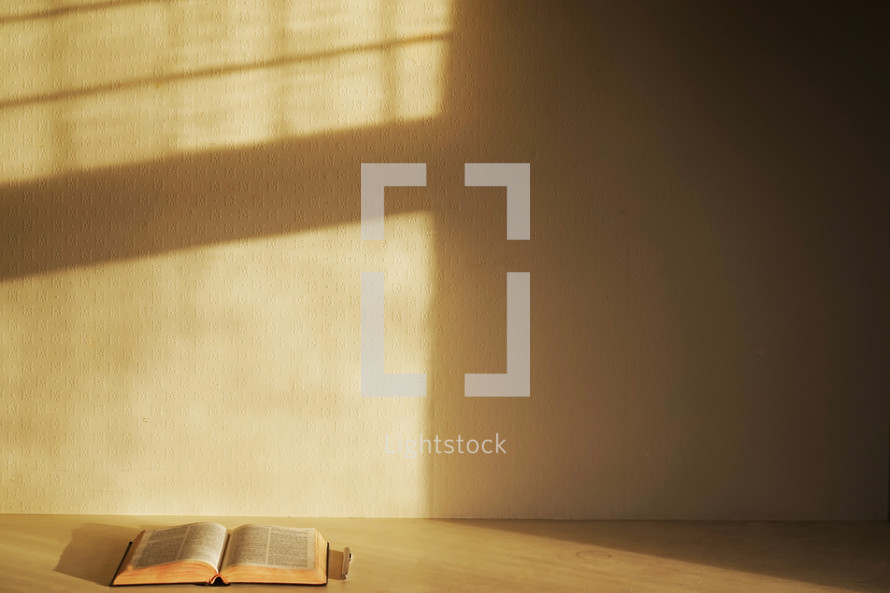 a Bible on pen in an empty room 