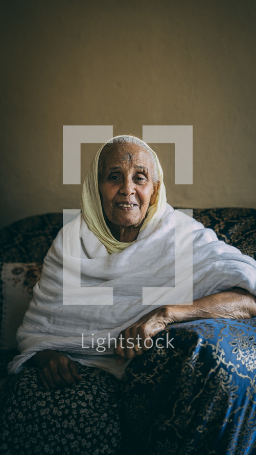 a smiling/ happy elderly woman