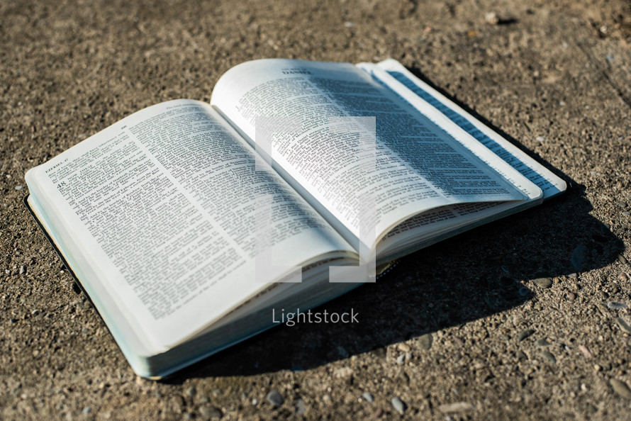 open Bible on concrete 